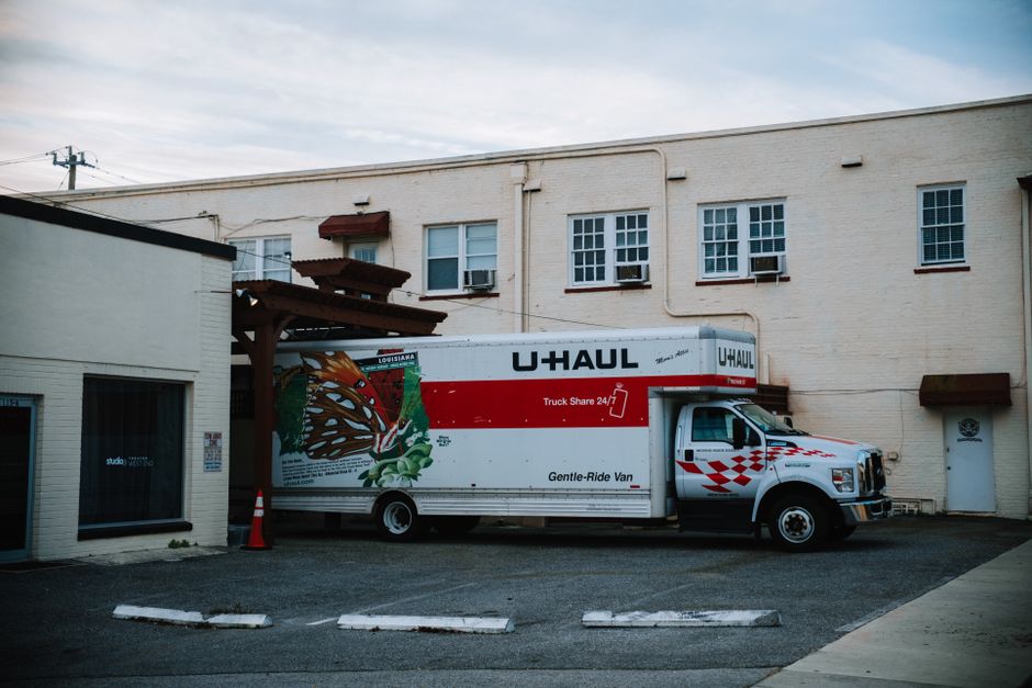 Professional movers loading furniture into a moving truck