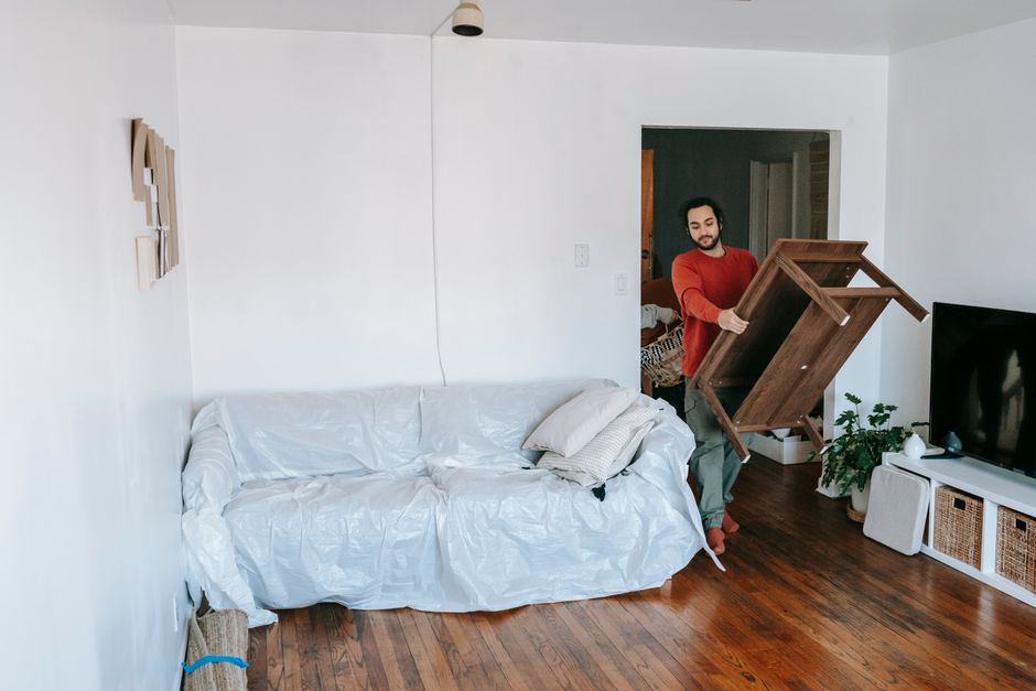Movers unpacking boxes and organizing a new living room space
